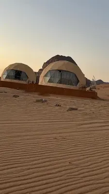 two domed tents in the middle of a desert at Wadi rum camp in Wadi Rum