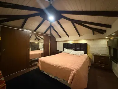 a bedroom with a large bed with a ceiling at City huts in Umm Uthainah