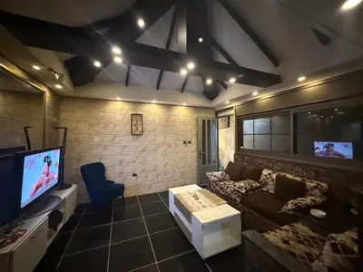a living room with a couch and a tv at City huts in Umm Uthainah
