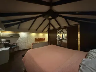 a bedroom with a white bed and a ceiling at City huts in Umm Uthainah