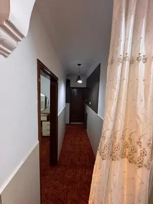 a hallway with a curtain next to a door at شقه للإيجار قرب جامعة اليرموك in Irbid