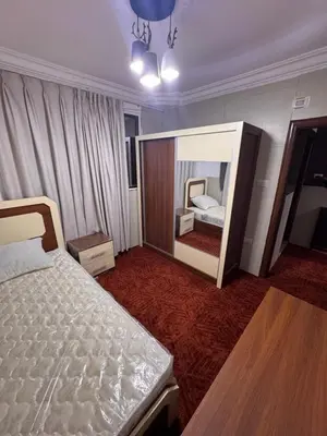 a hotel room with a bed and a mirror at شقه للإيجار قرب جامعة اليرموك in Irbid