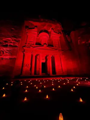 a building lit up in red with a bunch of lights at Salem Guesthouse Experience in Al Ḩayy
