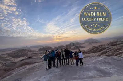 a group of people standing on the top of a mountain at Wadi Rum Luxury Trend in Wadi Rum