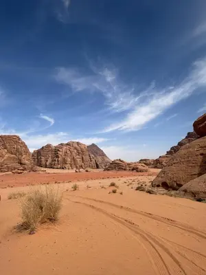 a dirt road in the desert with rocky mountains at Wadi Rum Luxury Trend in Wadi Rum