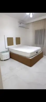 a room with a bed in a hospital room at Dair Ighbar Apartment
