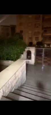 a blurry picture of a stairway with a building at Dair Ighbar Apartment