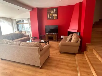 a living room with two couches and a flat screen tv at Horizon 3 in Al Qarţū‘īyah