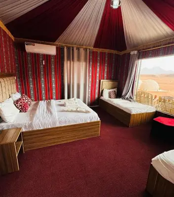 a bedroom with two beds in a tent at ULORA Luxury Camp in Wadi Rum