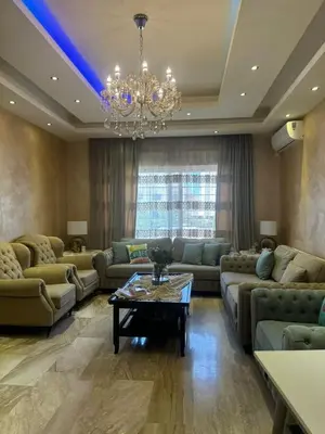 a living room with couches and a chandelier at In Balm Society ضاحية النخيل BR 3 Super Deluxe in Amman