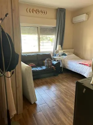 a living room with a couch and a bed at In Balm Society ضاحية النخيل BR 3 Super Deluxe in Amman