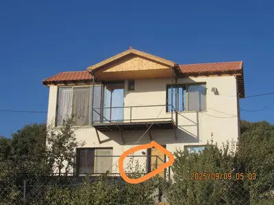 a house with an orange sign in front of it at اكواخ الملول عجلون 2 in Ajloun