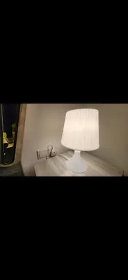 a white lamp sitting on top of a table at Qqq in Amman