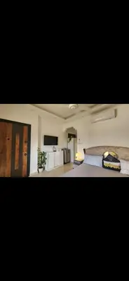 a bedroom with a bed and a television in it at Qqq in Amman