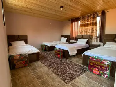 a room with three beds in a room at Naif Bedouin tour in Wadi Rum