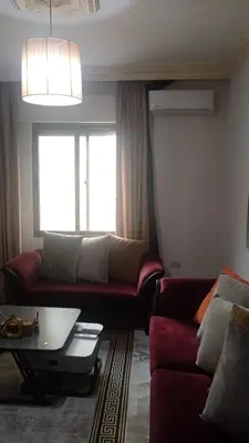 a living room with a couch and a table at Studio at the heart of Jabl Amman in Amman