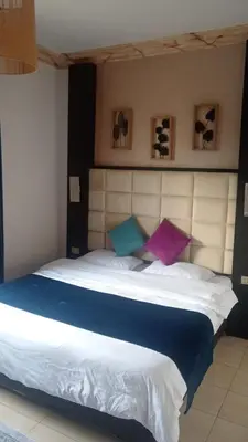 a bedroom with a large bed with two pillows at Studio at the heart of Jabl Amman in Amman