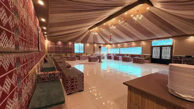 a large room with a swimming pool in a building at Hello Desert Camp & Tour
