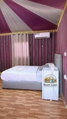 a bed in a tent with a box next to it at Rum Lian Luxury Camp & Bubble Hotel in Disah