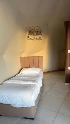 a bed in a room with a sign on the wall at Rum Lian Luxury Camp & Bubble Hotel in Disah