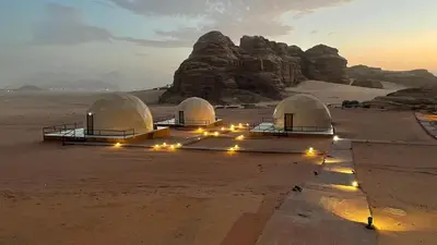 a group of domes in the desert with lights at Wadi Rum -Lekshary Hamza 55 in Wadi Rum