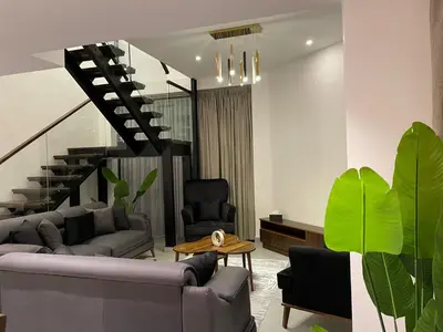 a living room with a couch and a table at luxury apartments at DAMAC tower amman للعائلات برج داماك in Amman