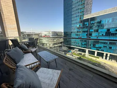 a balcony with couches and a view of a building at luxury apartments at DAMAC tower amman للعائلات برج داماك in Amman