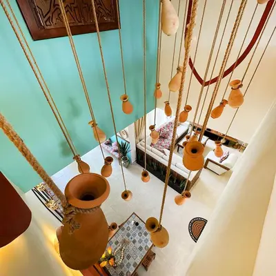an overhead view of a living room with pots hanging from the ceiling at Sultana Villa by Seahorse in Al Rama