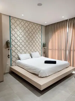 a bedroom with a large bed with a large window at Sultana Villa by Seahorse in Al Rama