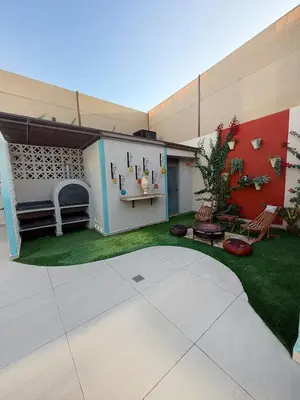 a house with a yard with a patio at Sultana Villa by Seahorse in Al Rama