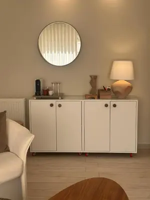 a living room with white cabinets and a mirror at 24h security, family friendly remodeled cozy space in Amman