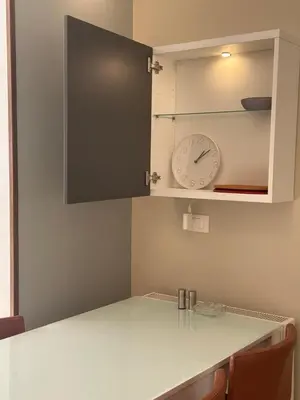 a kitchen counter with a clock in a cabinet at 24h security, family friendly remodeled cozy space in Amman