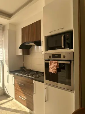 a kitchen with a stove top oven and a microwave at 24h security, family friendly remodeled cozy space in Amman