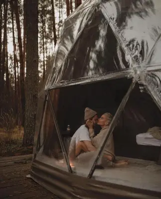 two people sitting inside of a tent at Rum nore in Disah