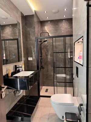 a bathroom with a toilet and a sink and a shower at Modern apartment near the UK embassy in abdoun in Amman