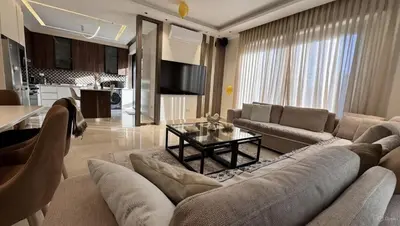 a living room with a couch and a table at Modern apartment near the UK embassy in abdoun in Amman
