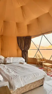 a bedroom with a bed and a large window at Yazeed in Disah