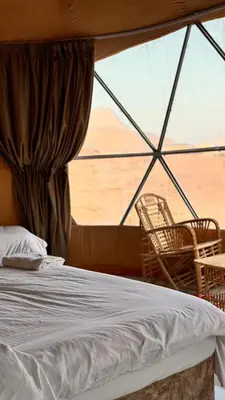 a bed and chairs in a room with a window at Yazeed in Disah