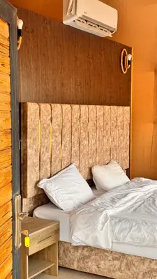 a bed with white sheets and pillows in a room at Yazeed in Disah
