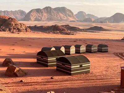 a group of four domes in the desert at Wadi Rum Mountains in Wadi Rum