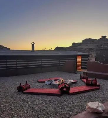 a group of red blankets on the ground with a lighthouse at Wadi Rum Mountains in Wadi Rum