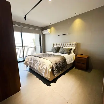 a bedroom with a bed and a large window at Haifa Villa by Seahorse in Sowayma