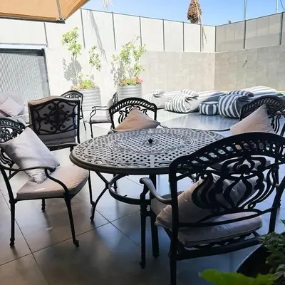 a table and chairs sitting on a patio at Haifa Villa by Seahorse in Sowayma
