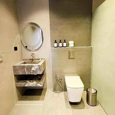 a bathroom with a sink and a toilet and a mirror at Haifa Villa by Seahorse in Sowayma