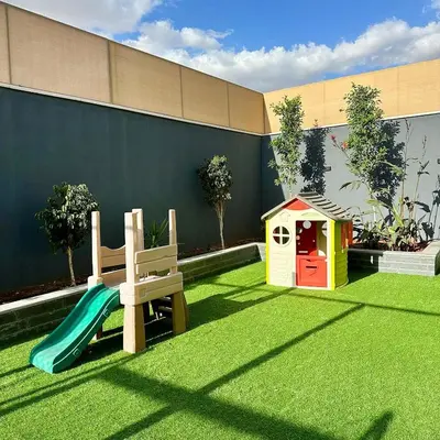 a playground with a slide and a play house at La Mer Villa by Seahorse in Al Rama