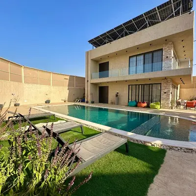 a swimming pool in front of a building at Tonay I Villa by Seahorse in Al Rama