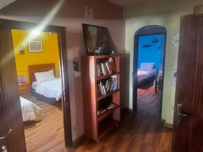 a bedroom with a bed and a book shelf at Petra Neighbor Hostel in Petra
