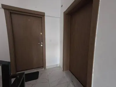 a hallway with two wooden doors in a room at 220 sqm 3 BR Um Al Summag, Makka Street
