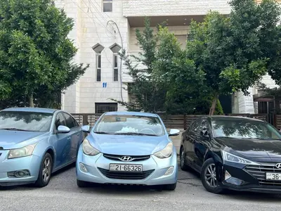 three cars parked next to each other in a parking lot at 220 sqm 3 BR Um Al Summag, Makka Street