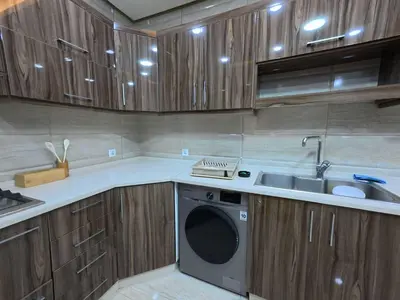 a kitchen with a washing machine and a sink at 220 sqm 3 BR Um Al Summag, Makka Street
